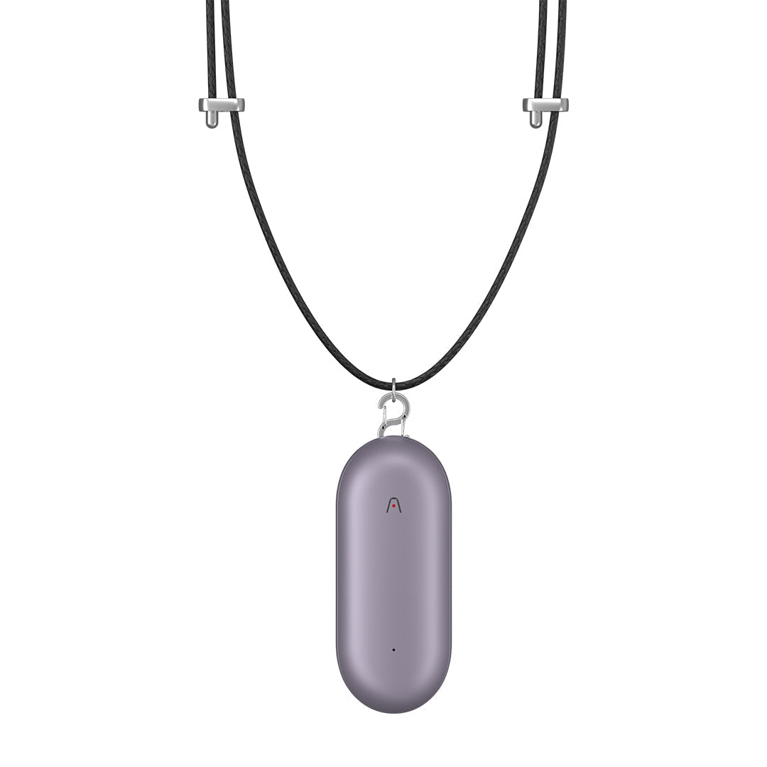 Purple Plaud NotePin AI voice recorder attached to a black lanyard necklace.