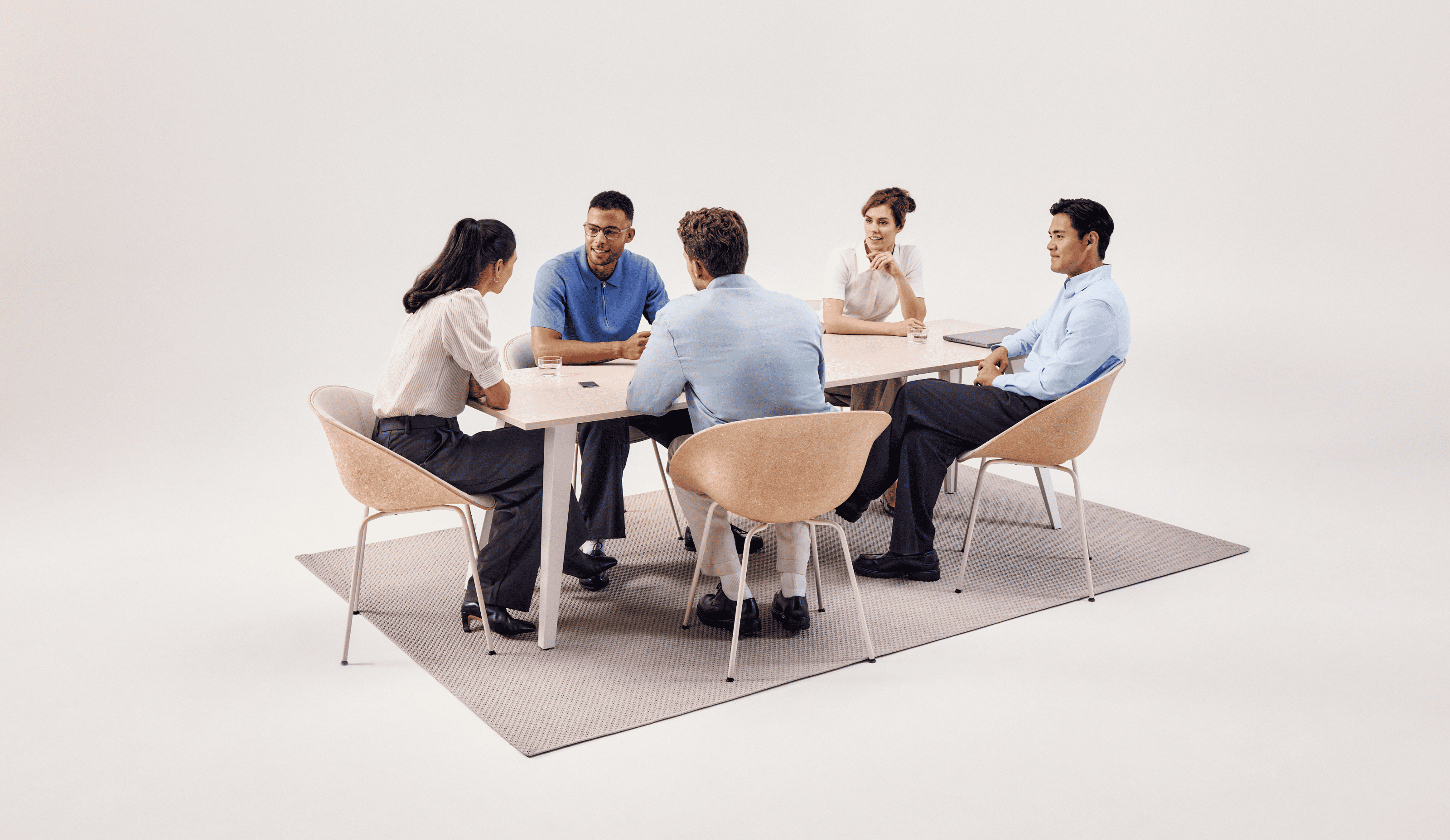 Five professionals in a meeting with a PLAUD NOTE on the table to record and transcribe the discussion.