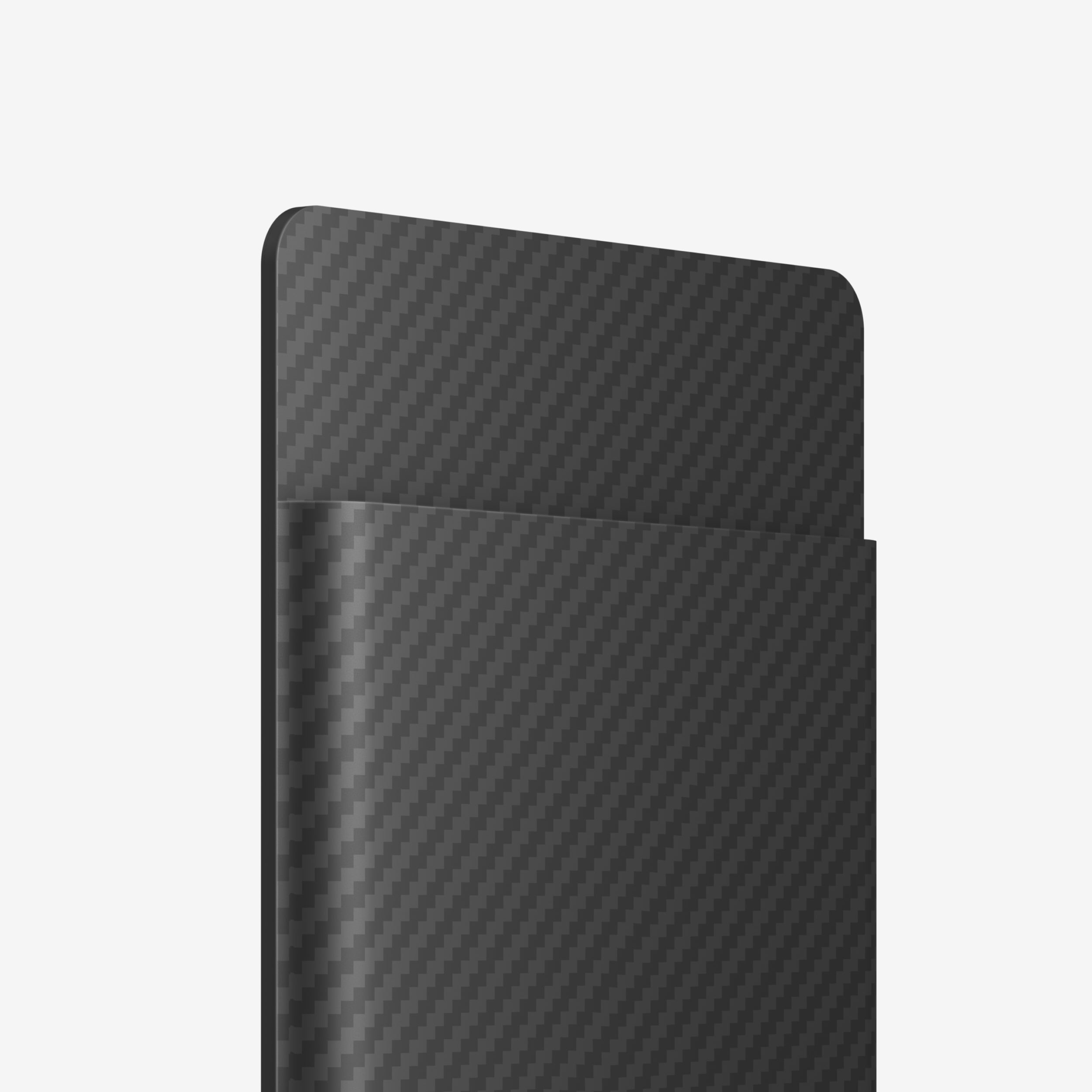 Close-up of the PLAUD NOTE AI voice recorder in a black carbon fiber textured MagSafe case.