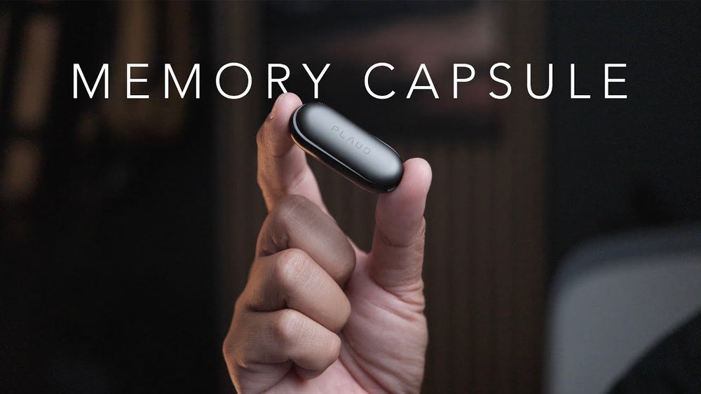 A hand holds the compact, capsule-shaped Plaud NotePin AI voice recorder under the text Memory Capsule.