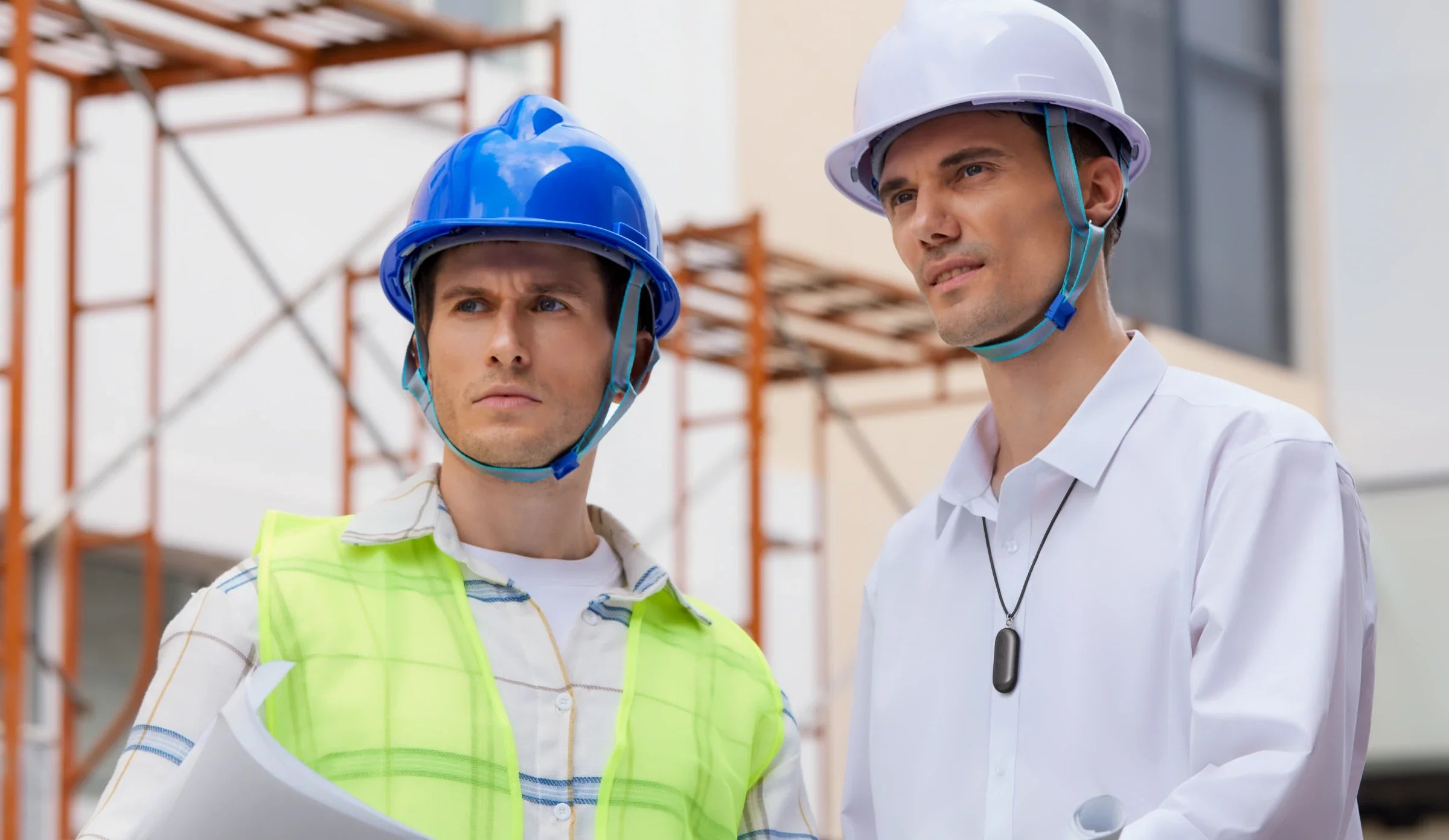 Construction professionals on-site, with one wearing a Plaud NotePin necklace for hands-free voice recording.