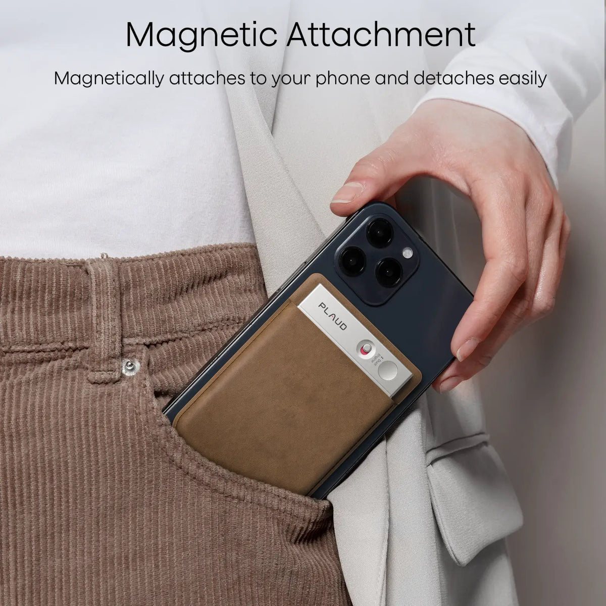 A Plaud Note AI voice recorder magnetically attached to the back of a smartphone being placed into a pocket.