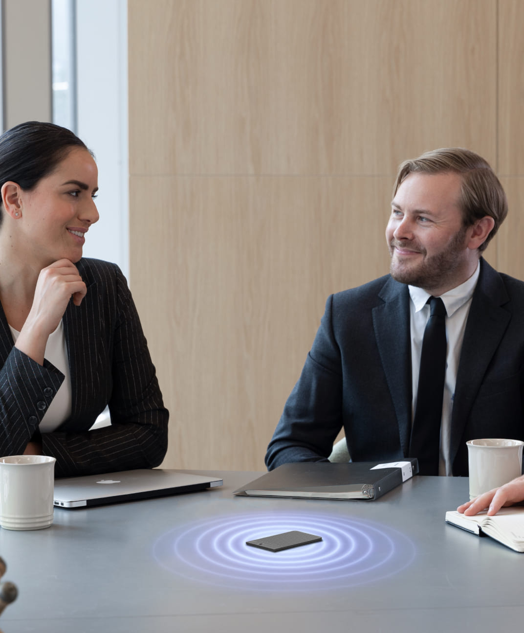 PLAUD NOTE recording a business meeting between two professionals in an office setting.