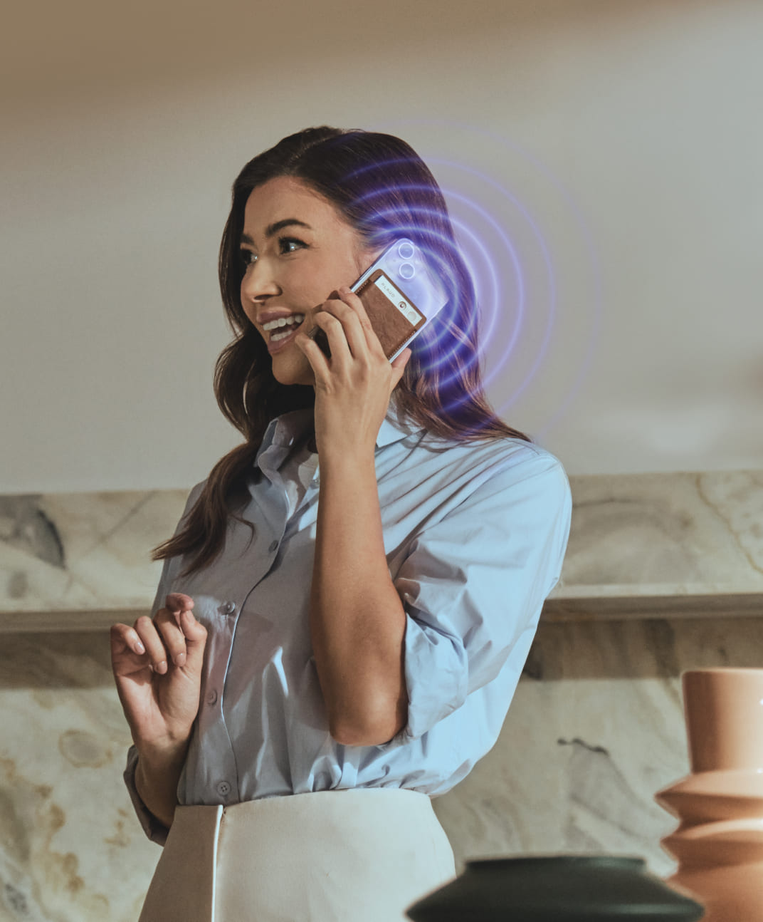 Woman recording a phone call with a Plaud Note AI voice recorder attached to her smartphone.